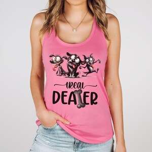 May include: Pink tank top featuring a graphic of three cartoon dogs with excited expressions. The text "Treat Dealer" is printed below the dogs, with a bone graphic replacing the "O" in "Dealer".
