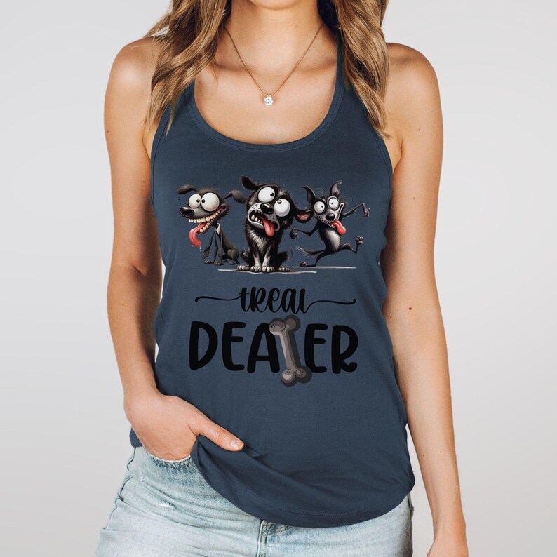 May include: Navy blue tank top featuring a playful graphic of three cartoon dogs with exaggerated expressions. The text "Treat Dealer" is below the dogs, with a bone graphic. The top is sleeveless and has a scoop neck.