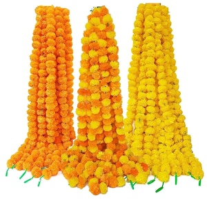 May include: Three strands of artificial marigold flower garlands in yellow and orange. The garlands are made of individual flower heads and are strung together.