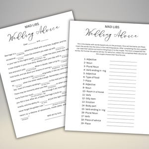 May include: Two white sheets of paper with the text "MAD LIBS Wedding Advice" in elegant script. One sheet has fill-in-the-blank prompts, the other has a completed example. A fun activity for a wedding.