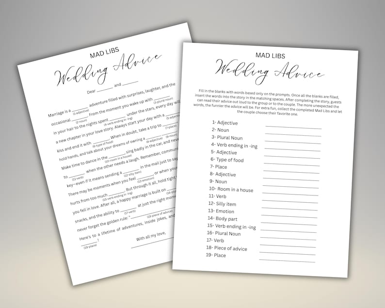 May include: Two white sheets of paper with the text "MAD LIBS Wedding Advice" in elegant script. One sheet has fill-in-the-blank prompts, the other has a completed example. A fun activity for a wedding.