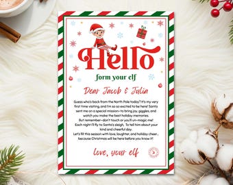 Peut inclure: Une lettre de Noël festive avec une bordure rouge et verte. La lettre présente le mot "Hello" en grandes lettres rouges, ainsi qu'une illustration d'un elfe. Le texte comprend un message d'un elfe à "Jacob & Julia".