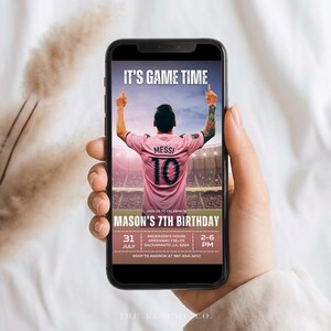 Puede incluir: Un smartphone muestra una invitaci&oacute;n digital para una fiesta de cumplea&ntilde;os con tem&aacute;tica de f&uacute;tbol. La invitaci&oacute;n presenta a un jugador de f&uacute;tbol con una camiseta rosa con el n&uacute;mero 10. El texto incluye "It's Game Time" y detalles de la fiesta.