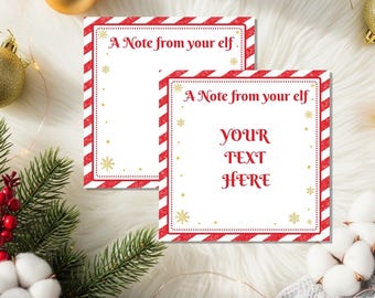 Op de afbeelding: Twee witte kaarten met rood-witte gestreepte randen en de tekst "A Note from your elf." Eén kaart heeft de tekst "YOUR TEXT HERE" in het rood. Gouden sneeuwvlokken en stippen versieren de kaarten.