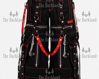 May include: Black pants with red stitching, zippers, and straps. The pants feature multiple pockets, metal chains, and studded accents. The Darkland logo is visible on the pants.