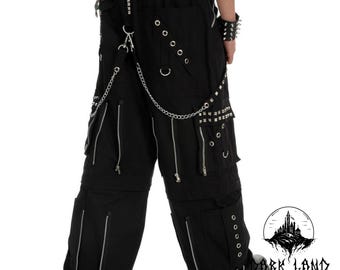 May include: Black cargo pants with multiple zippered pockets and silver studs. The pants have a chain attached to the belt loops.