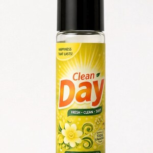 May include: A roll-on perfume oil bottle with a black cap. The label is yellow with the words "Clean Day" in orange, and "FRESH &bull; CLEAN &bull; SOFT" in green. The bottle contains 9.8 mL (0.33 fl oz) of perfume oil.