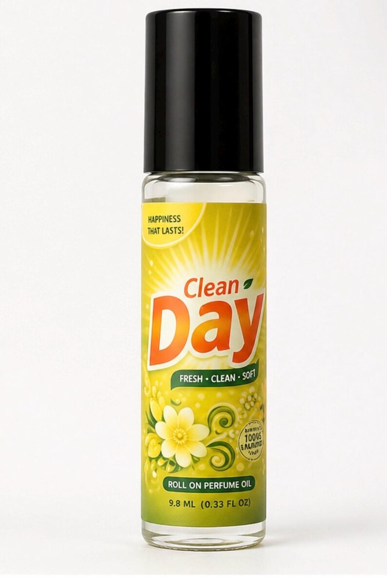 May include: A roll-on perfume oil bottle with a black cap. The label is yellow with the words "Clean Day" in orange, and "FRESH &bull; CLEAN &bull; SOFT" in green. The bottle contains 9.8 mL (0.33 fl oz) of perfume oil.