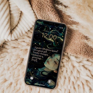 May include: A smartphone screen shows a digital art wallpaper featuring a woman's face and flowing hair in teal and gold tones. The time displayed is 12:00, with the text: "I make decisions based on a good gut, I make changes based on a growing heart."