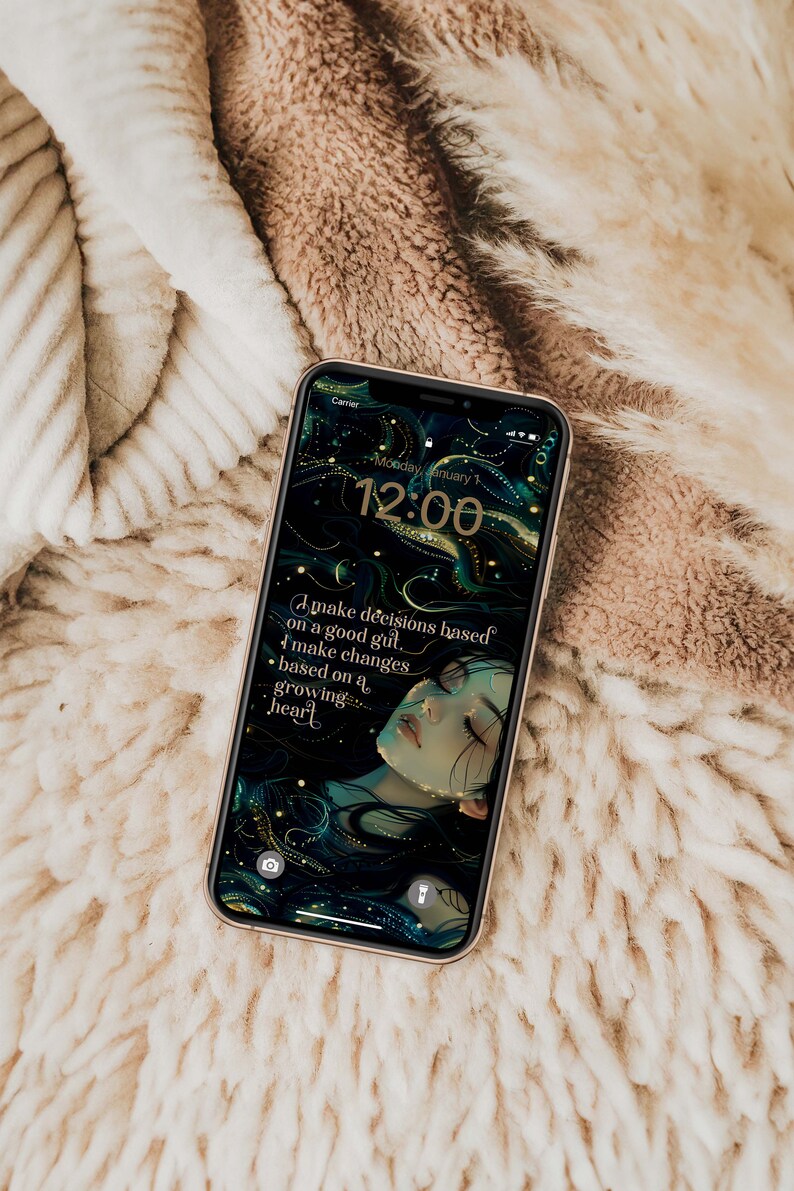 May include: A smartphone screen shows a digital art wallpaper featuring a woman's face and flowing hair in teal and gold tones. The time displayed is 12:00, with the text: "I make decisions based on a good gut, I make changes based on a growing heart."