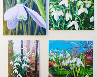 May include: Four paintings of snowdrops, a white flower that blooms in early spring. The paintings are all different styles, but they all feature the delicate beauty of the snowdrop.