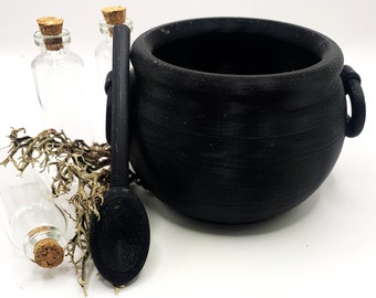 May include: A black cauldron with two handles, a black spoon, and three clear glass bottles with cork stoppers. Dried, light brown moss is next to the bottles. The cauldron is a key element in the image.