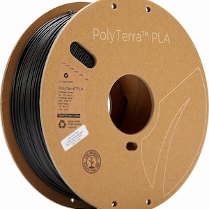 Może przedstawiać: Szpula czarnego filamentu PLA PolyTerra do druku 3D. Szpula jest wykonana z tektury i ma etykietę z instrukcjami drukowania i specyfikacjami. Etykieta zawiera tekst "PolyTerra™ PLA" i "Waga szpuli: 200 g".