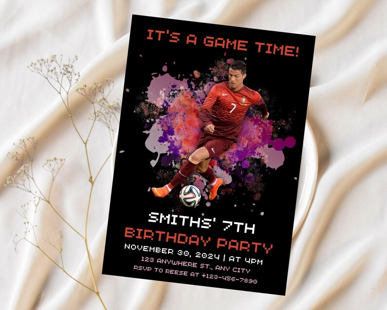 May include: A black and red birthday party invitation with a soccer player in a red and white jersey. The invitation says "It's a game time!" and "Smith's 7th Birthday Party". The invitation includes the date, time, location, and RSVP information.