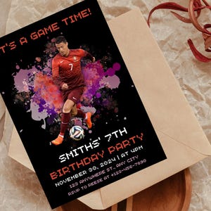 May include: A black and red birthday party invitation with a soccer player in a red and white jersey. The invitation says "It's a game time!" and "Smith's 7th Birthday Party".