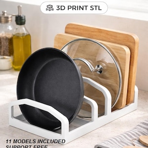 May include: White modular 3-slot pan and lid organizer. The organizer holds a black pan, a glass lid, and two wooden cutting boards. Text on the image reads "MODULAR 3-SLOT PAN & LID ORGANIZER" and "3D PRINT STL".