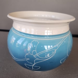 May include: A set of three ceramic mugs with a speckled, matte finish. The mugs are in shades of cream, light gray, and dark gray. Each mug has a simple, minimalist design, perfect for coffee or tea.