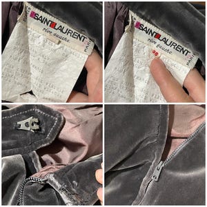 May include: Close-up of a vintage Saint Laurent garment. The label reads "SAINT LAURENT rive gauche PARIS" with details about the fabric composition and care instructions. The garment is a dark gray color, with a zipper and a metal clasp.