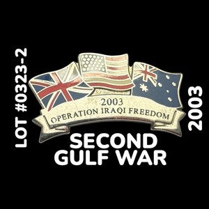 May include: A gold-colored pin with three flags: the United States, the United Kingdom, and Australia. The flags are arranged in a semi-circle around a banner that reads "2003 Operation Iraqi Freedom". Below the banner is the text "Second Gulf War".