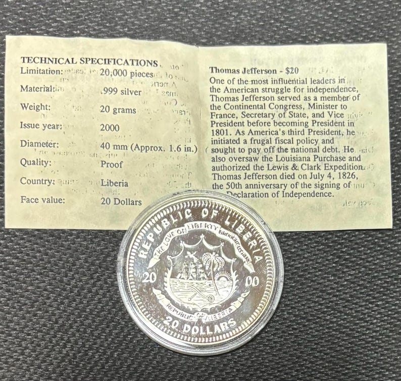 May include: A silver coin from the Republic of Liberia, featuring a sailing ship and palm trees. The coin has a face value of 20 dollars and a diameter of approximately 40 mm. The coin is made of .999 silver and weighs 20 grams.