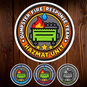 May include: A circular embroidered patch featuring a green dumpster with red and yellow flames and a blue water droplet. The orange border contains the text DUMPSTER FIRE RESPONSE TEAM and HAZMAT UNIT in black, with three yellow stars at the bottom.