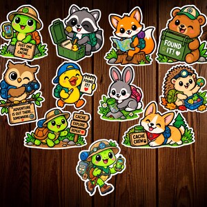 May include: A collection of eleven die-cut stickers featuring cartoon animals engaged in geocaching activities. The characters include turtles, a raccoon, a fox, a bear, an owl, a duck, a rabbit, a hedgehog, and a corgi, with text like FOUND IT.