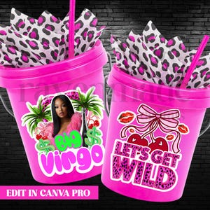 May include: Two pink buckets with decorative stickers and straws. One bucket has a sticker with a woman, palm trees, cherries, and the words "Big Virgo." The other bucket has cherries, lips, a bow, and the words "Let's Get Wild."