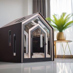 May include: A dark brown pet house with a gabled roof, featuring a clear glass front door and side panels. The structure has a light-colored trim around the door frame and includes a soft, white cushioned interior floor for comfort and rest.