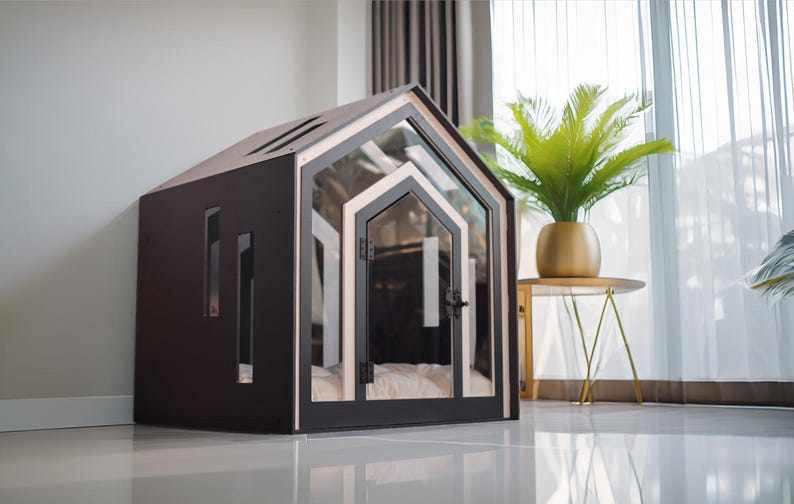 May include: A dark brown pet house with a gabled roof, featuring a clear glass front door and side panels. The structure has a light-colored trim around the door frame and includes a soft, white cushioned interior floor for comfort and rest.