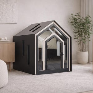 May include: A dark gray pet house shaped like a small cottage with a gabled roof, featuring a light-colored trim around the front door frame, a glass-paneled door with a black handle, and vertical rectangular cutouts on the side wall.