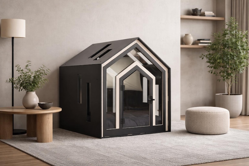 May include: A black pet house with a gabled roof, featuring a light-colored wood trim around the front entrance and a glass door with a black handle. The structure has rectangular side cutouts and a slanted roof design with two narrow openings.