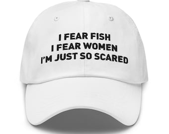 May include: White baseball cap with the text "I FEAR FISH I FEAR WOMEN I'M JUST SO SCARED" in black block letters. The cap has a curved brim and an adjustable strap at the back.