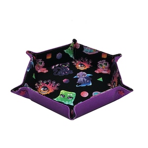 May include: Purple dice rolling tray with a black interior featuring a colorful print of various fantasy creatures and geometric shapes.