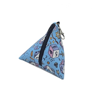 May include: A blue triangular zippered pouch with a dice pattern. The pouch has a silver zipper pull and a silver key ring.