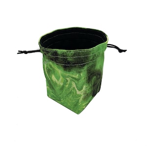 May include: A green and black marbled dice bag with a black interior and drawstring closure. The bag is made of fabric and is designed to hold dice or other small items. The bag is shown against a white background.