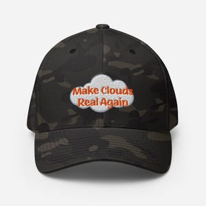 May include: A black camouflage baseball cap with the phrase "Make Clouds Real Again" in orange text inside a white cloud graphic. The cap has a curved brim and a structured fit.