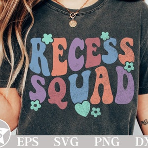 May include: A dark grey t-shirt with a retro-style graphic that says "Recess Squad" in colorful letters with flowers and a heart.
