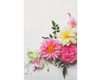 May include: A rectangular print featuring a vibrant floral arrangement on a white wood-grain background. The bouquet includes a large pink dahlia, a creamy yellow dahlia, a deep pink rose, and delicate light pink fuchsia blossoms with green leaves.