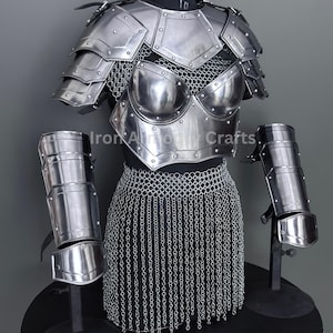 May include: A polished steel breastplate, shoulder armor, and arm guards are displayed on a mannequin. The armor features riveted plates and chainmail accents. The set is designed for protection and is suitable for cosplay or historical reenactments.