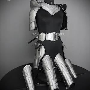 May include: Silver plated armor set for LARP or cosplay. The set includes shoulder pads, chest plate, leg guards, and arm guards. The armor is made of metal and has a polished finish.