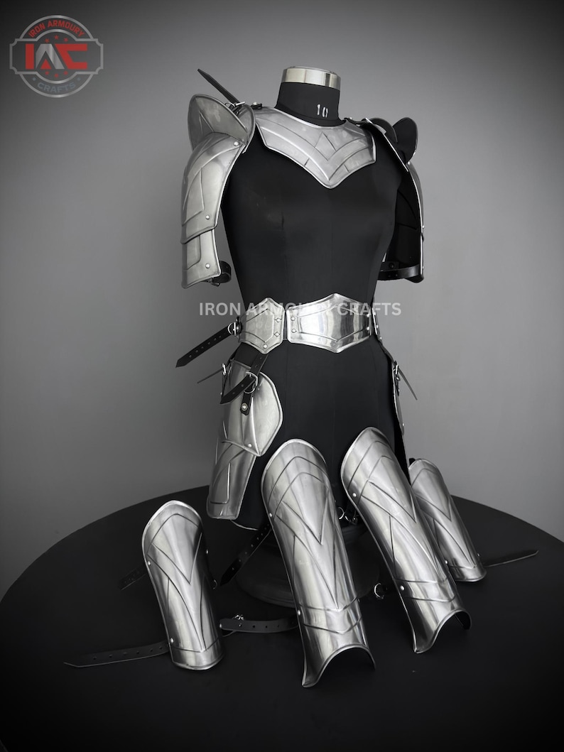 May include: Silver plated armor set for LARP or cosplay. The set includes shoulder pads, chest plate, leg guards, and arm guards. The armor is made of metal and has a polished finish.