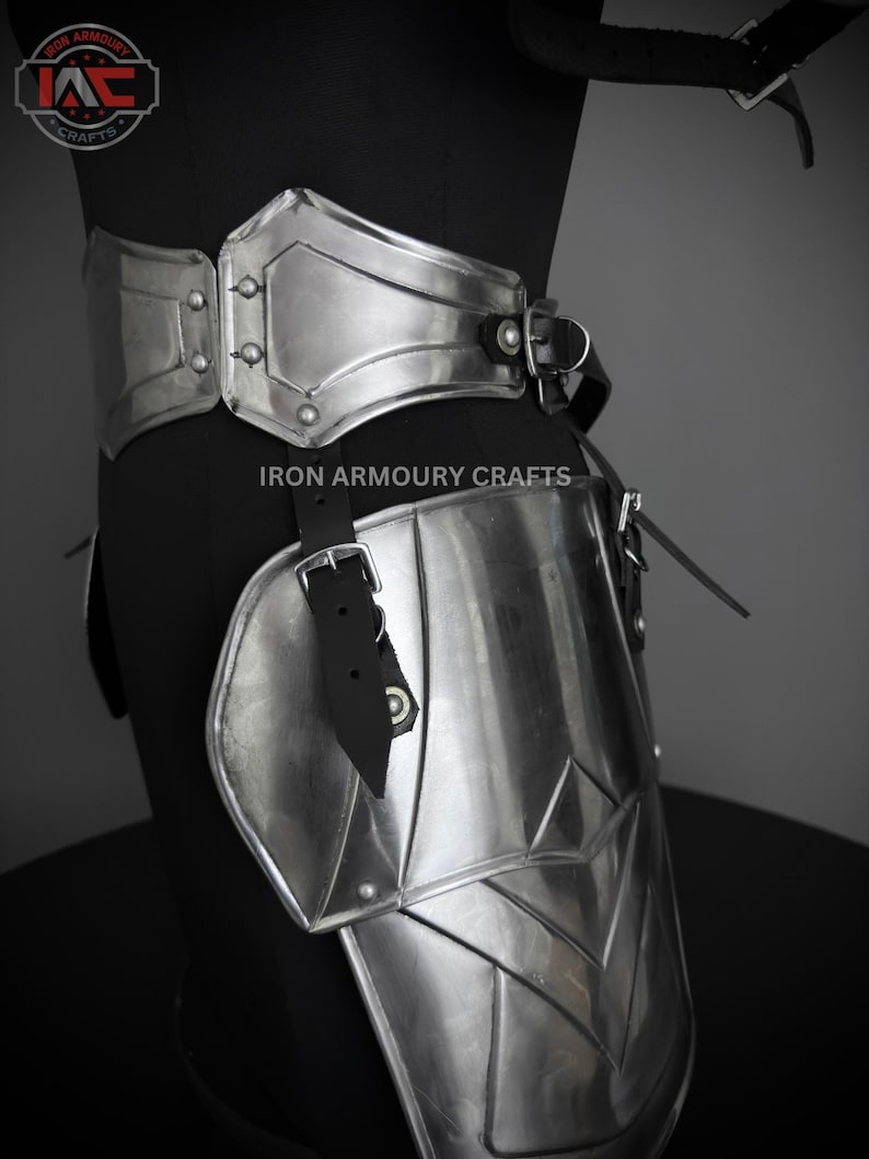 May include: Silver metal armor for the legs and waist. The armor is made of multiple plates and is secured with leather straps. The armor is designed to protect the wearer from injury.