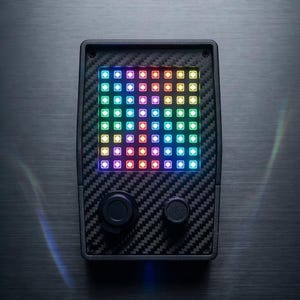 May include: A handheld electronic device with a carbon fiber textured casing. The device features a grid of multi-colored LED lights and two black control knobs. The screen displays a vibrant array of colors.