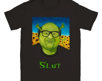May include: Black t-shirt featuring a green Shrek-like character wearing glasses and a field of sunflowers in the background. The text "SLUT" is printed in green below the character.