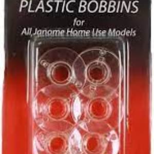 May include: A pack of clear plastic bobbins for Janome home use sewing machines. The pack is red and black with the text "JANOME PLASTIC BOBBINS for All Janome Home Use Models".