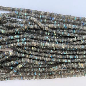 May include: A strand of gray labradorite gemstone beads. The beads are small and round, with a slight iridescent sheen.