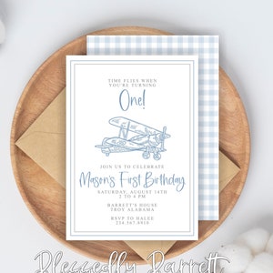 May include: Blue and white airplane themed first birthday party invitation with the text "Time flies when you're turning One!" and "Join us to celebrate Mason's First Birthday" with the date, time, and location of the party.