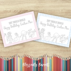 May include: Two coloring pages with nursery rhyme illustrations and text. One page has a pink gingham border, the other a blue gingham border. Text includes "HEY DIDDLE DIDDLE" and "Happy Birthday, Caroline Mae." A row of colored pencils is at the bottom.