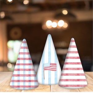 May include: Three party hats with red, white, and blue patterns. The hats are made of paper and have a pointed tip. One hat has a red, white, and blue striped pattern, another has a red and blue gingham pattern, and the third has a blue and white striped pattern with a small American flag.