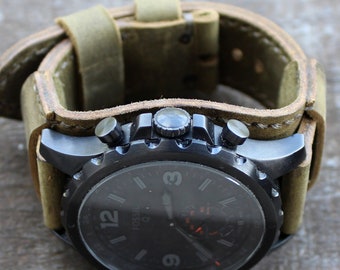May include: A black Fossil watch with a dark face and a tan leather strap. The watch has silver detailing and a chronograph design. The strap is wide and has a buckle fastening. The watch is a stylish accessory, suitable for everyday wear.